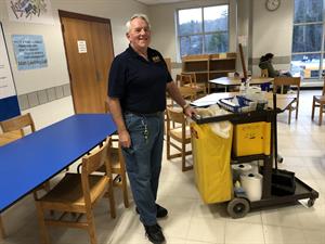 Royce 1 Michael Royce standing beside his custodian cart in school classroom